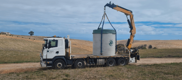 Truck delivering Ri-Industries concrete septic tank